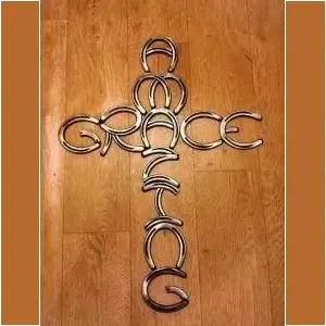 "amazing grace" spelled out in the shape of a cross made of horseshoes