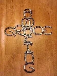 "amazing grace" spelled out in the shape of a cross made of horseshoes